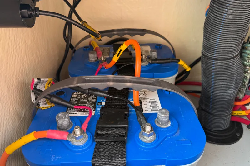 Slide: The Image of Blue marine batteries with cables in a 2020 Maverick 18 HPX-V boat. - 43