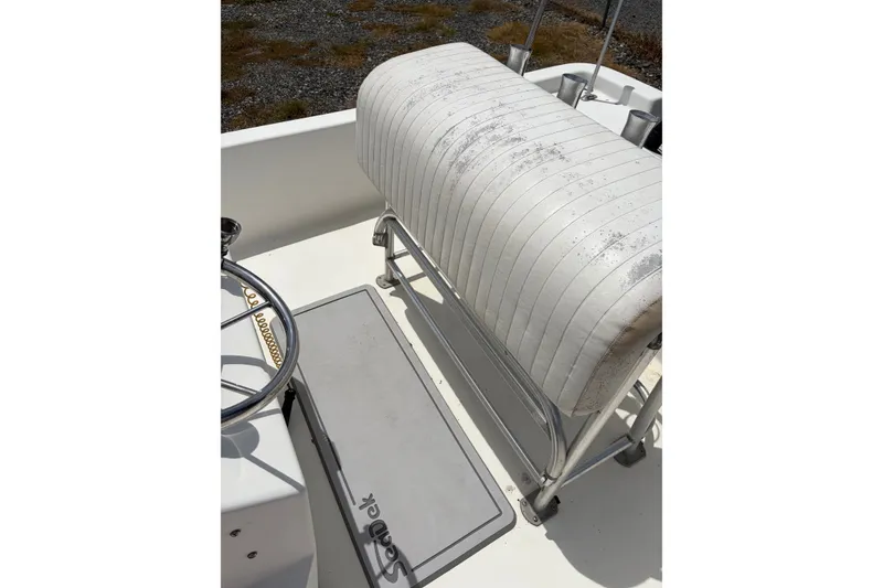 Slide: The Image of 2008 Blazer Bay 1960 boat interior with white seating and steering wheel. - 8