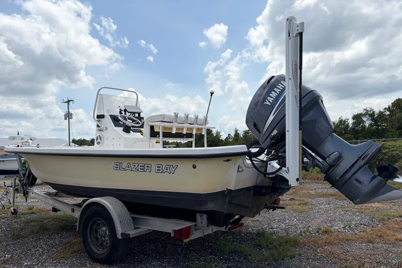 The Image of 2008 Blazer Bay 1960 Bay boat with Yamaha motor on trailer under cloudy sky. - 1