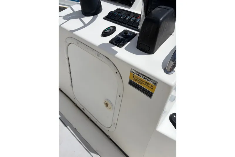 Slide: The Image of 2008 Blazer Bay 1960 Bay boat console with controls and capacity label. - 13