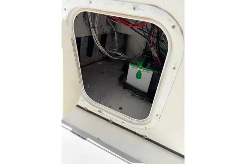 Slide: The Image of Battery compartment of a 2008 Blazer Bay 1960 Bay boat, showing wiring and battery. - 12