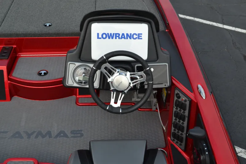Slide: The Image of 2021 Caymas CX 19 boat dashboard with Lowrance display and steering wheel. - 8