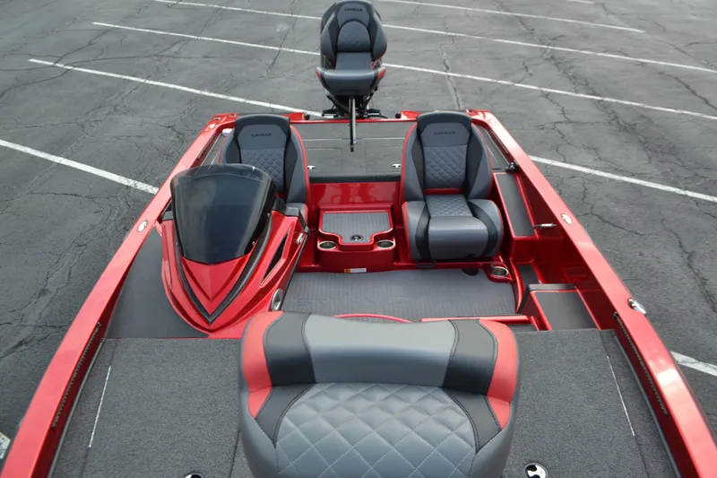 Slide: The Image of 2021 Caymas CX 19 boat interior with red and gray seating in a parking lot. - 9