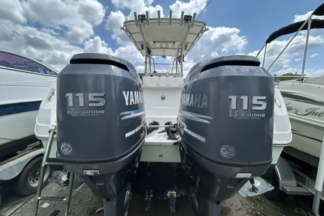 Slide: The Image of Twin Yamaha 115 outboard engines on a 2007 Sailfish 2360 CC boat under a cloudy sky. - 5