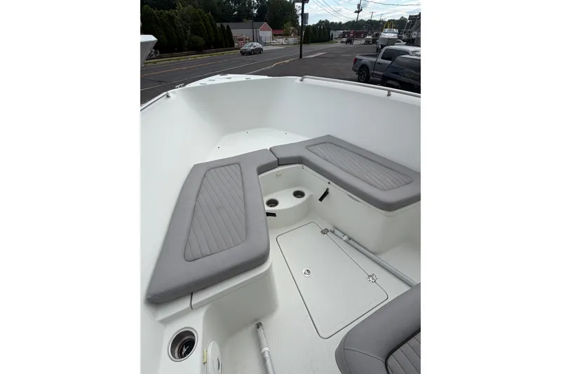 Slide: The Image of 2007 Sailfish 2360 CC boat interior with gray cushioned seating and storage compartments. - 11
