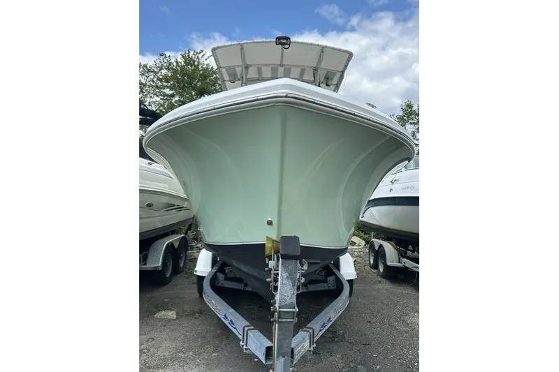 Slide: The Image of 2007 Sailfish 2360 CC boat on trailer, front view, parked outdoors. - 17