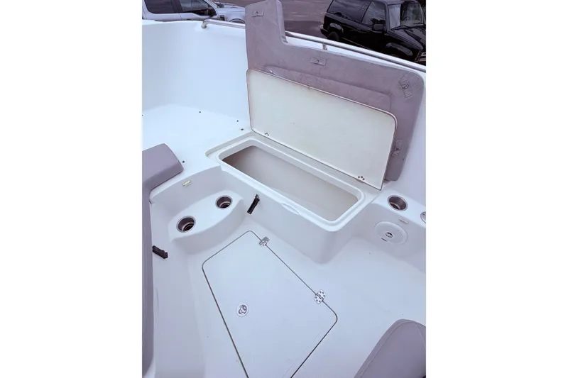 Slide: The Image of 2007 Sailfish 2360 CC boat interior with open storage compartment and cup holders. - 13