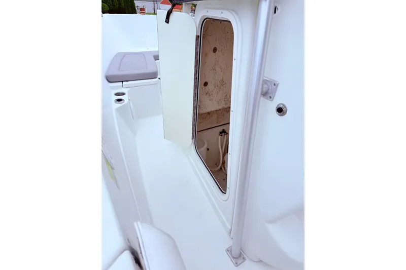 Slide: The Image of Open storage compartment on a 2007 Sailfish 2360 CC boat interior. - 14