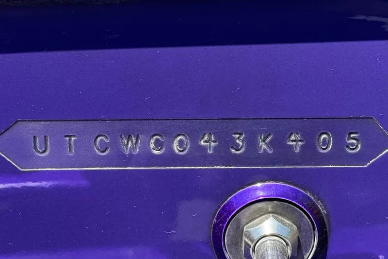Slide: The Image of VIN plate on a 2005 Ultimate Warlock 25 World Class boat, purple background. - 26