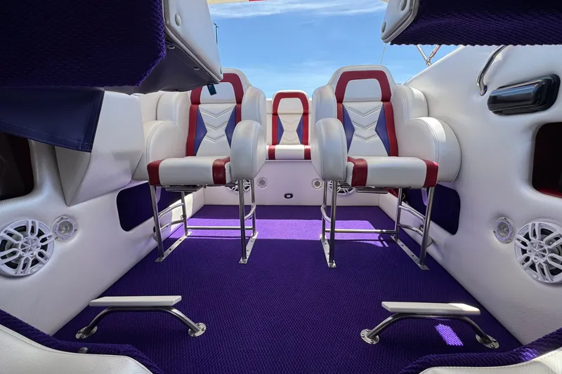 Slide: The Image of Luxurious interior of a 2005 Ultimate Warlock 25 World Class boat with purple carpet. - 15