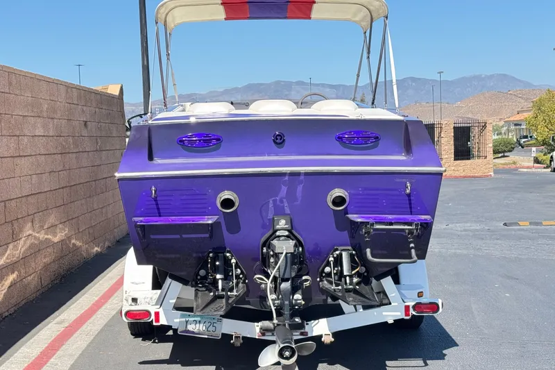 Slide: The Image of Rear view of a 2005 Ultimate Warlock 25 World Class boat in a parking lot. - 4