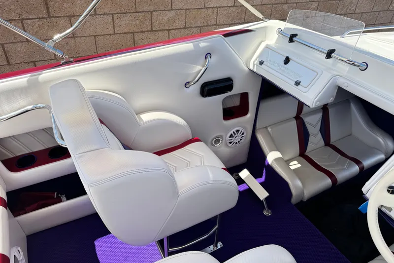 Slide: The Image of Interior of a 2005 Ultimate Warlock 25 World Class boat with white seating and purple carpet. - 20