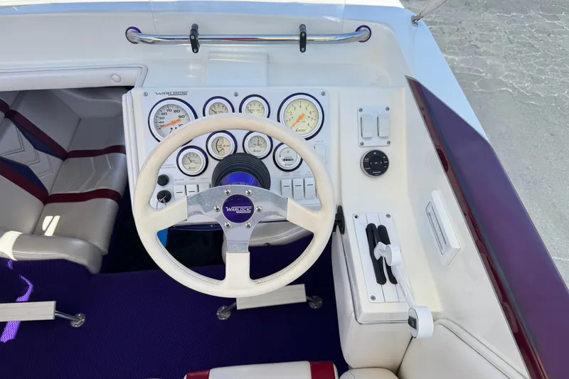 Slide: The Image of Cockpit of 2005 Ultimate Warlock 25 World Class boat with steering wheel and gauges. - 23