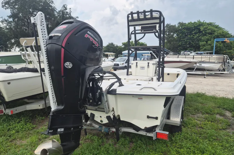 Slide: The Image of 2018 Mako Pro Skiff 19 CC Top Drive boat with Mercury engine, parked on trailer. - 3