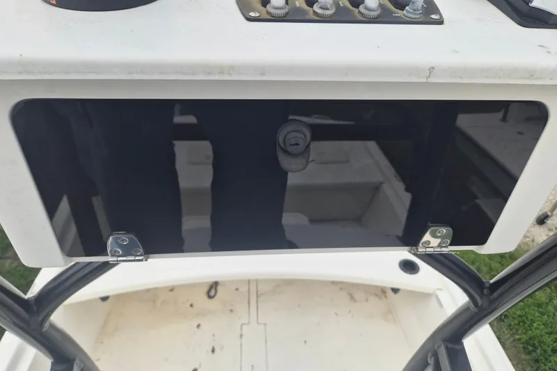 Slide: The Image of 2018 Mako Pro Skiff 19 CC Top Drive console with control panel and storage compartment. - 20