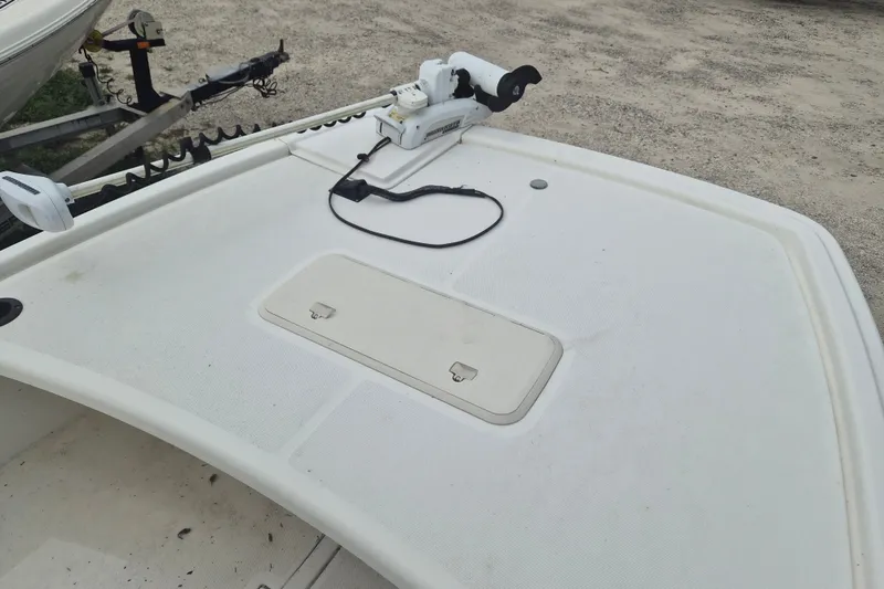 Slide: The Image of 2018 Mako Pro Skiff 19 CC Top Drive boat deck with trolling motor and storage hatch. - 14