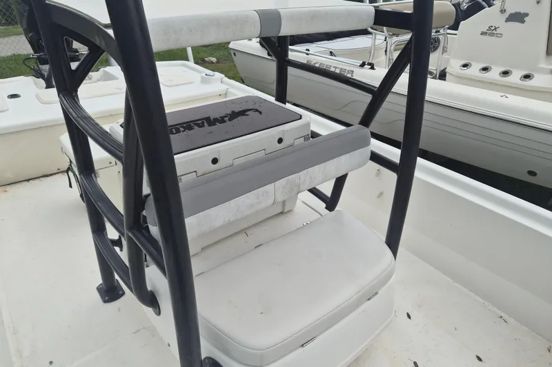 Slide: The Image of 2018 Mako Pro Skiff 19 CC Top Drive boat interior with seating and storage. - 12
