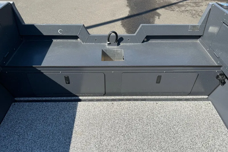 Slide: The Image of 2027 Alumaweld Adventurer 22 boat interior with storage compartments and a small sink. - 24