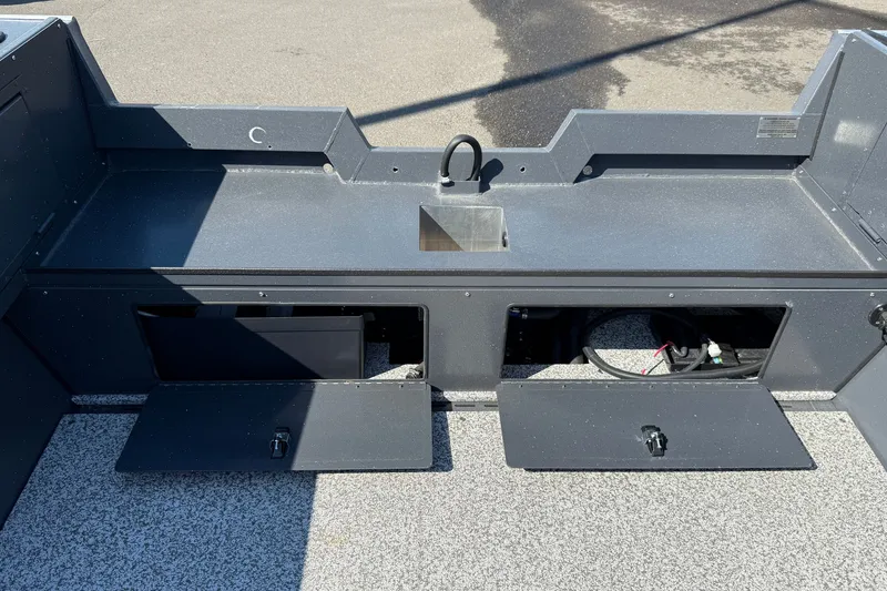 Slide: The Image of 2027 Alumaweld Adventurer 22 boat interior with storage compartments and utility sink. - 22