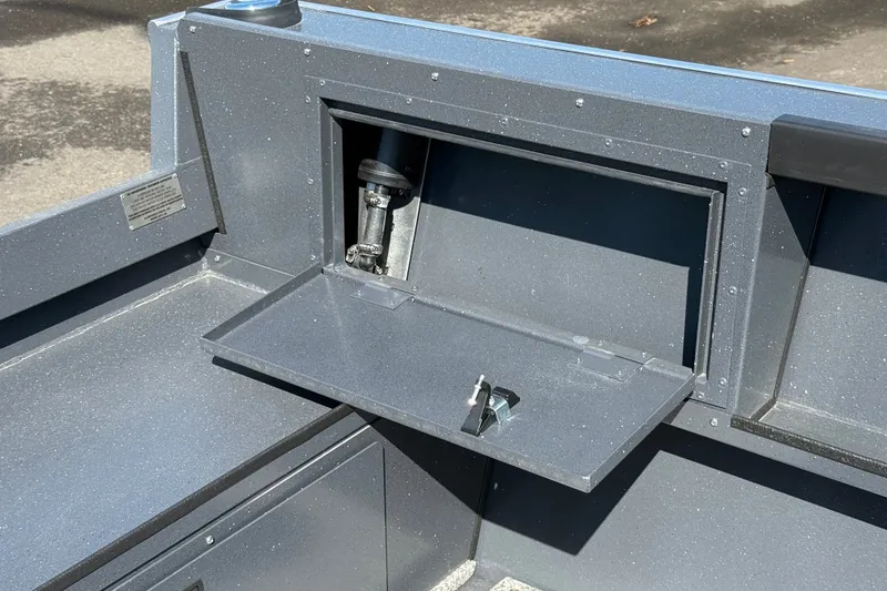 Slide: The Image of 2027 Alumaweld Adventurer 22 boat interior with foldable storage compartment and latch mechanism. - 21