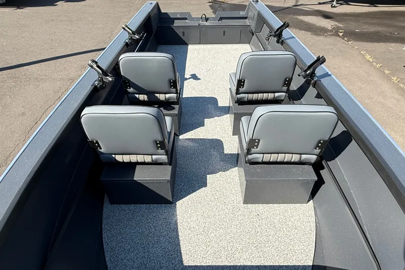 Slide: The Image of 2027 Alumaweld Adventurer 22 boat interior with four gray seats and rod holders. - 12