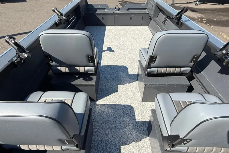 Slide: The Image of 2027 Alumaweld Adventurer 22 boat interior with four gray seats and rod holders. - 15