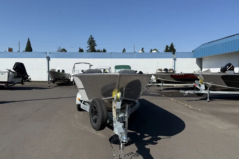 Slide: The Image of 2027 Alumaweld Adventurer 22 boat on trailer in outdoor dealership lot. - 2