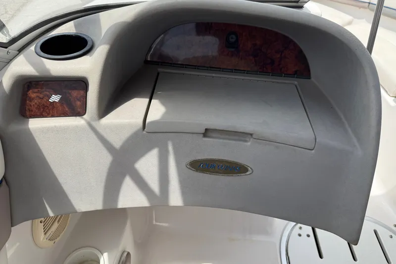 Slide: The Image of Dashboard of a 2003 Four Winns 190 Horizon boat with storage compartment. - 14