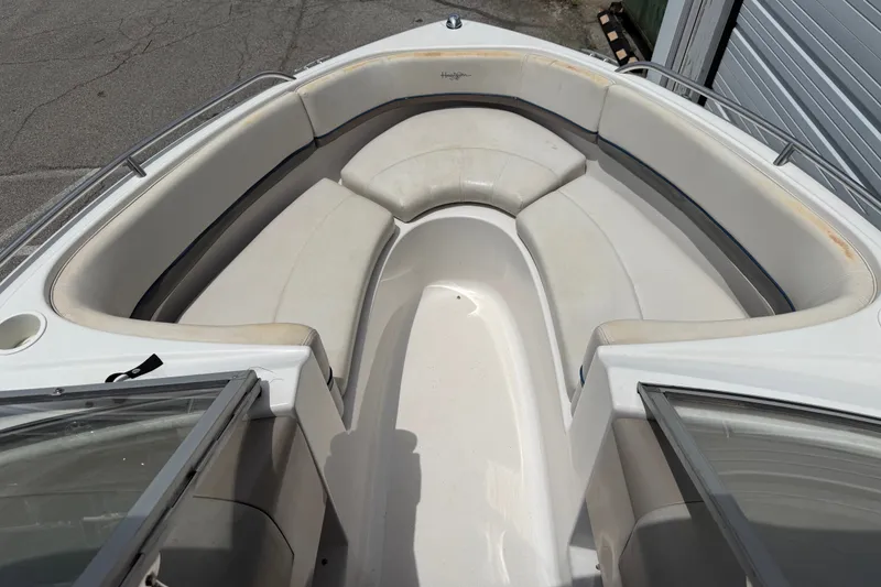 Slide: The Image of 2003 Four Winns 190 Horizon boat interior with white cushioned seating. - 12