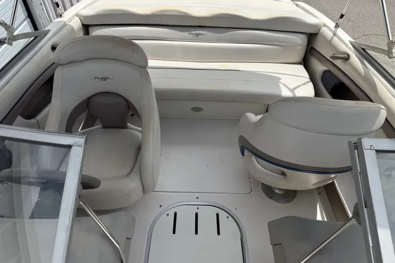 Slide: The Image of 2003 Four Winns 190 Horizon boat interior with white seating and steering area. - 10