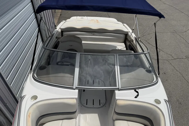 Slide: The Image of 2003 Four Winns 190 Horizon boat with blue canopy and white interior. - 9