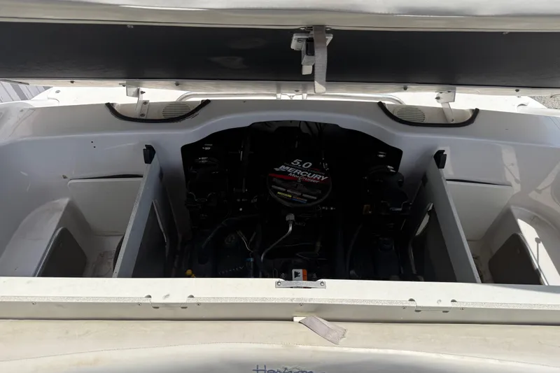 Slide: The Image of Open engine compartment of 2003 Four Winns 190 Horizon boat, featuring a Mercury 5.0 engine. - 20