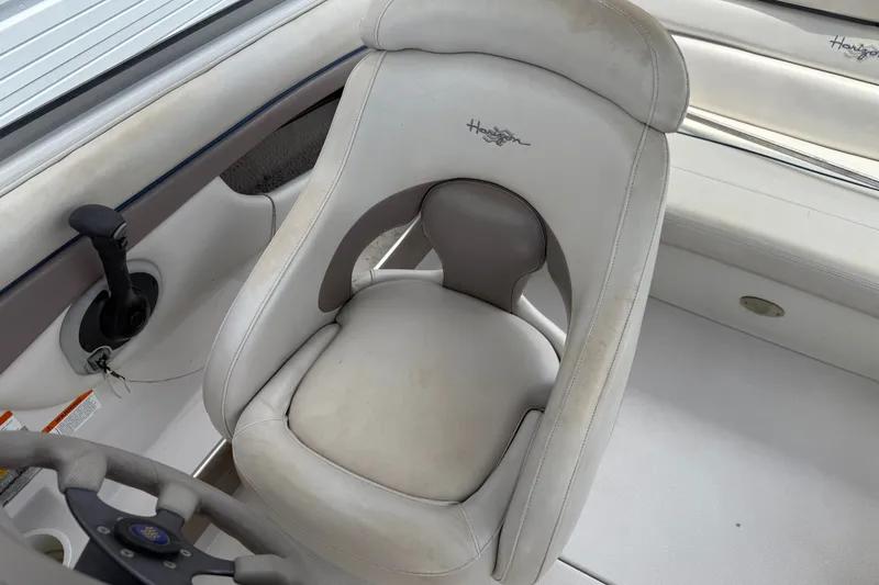Slide: The Image of 2003 Four Winns 190 Horizon boat interior with steering wheel and seat. - 16