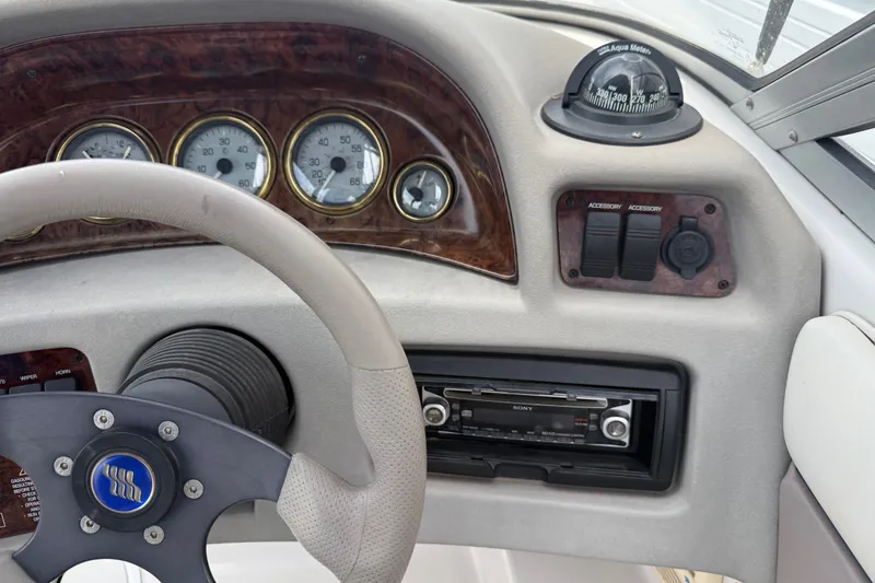 Slide: The Image of Dashboard of a 2003 Four Winns 190 Horizon boat with steering wheel and gauges. - 18