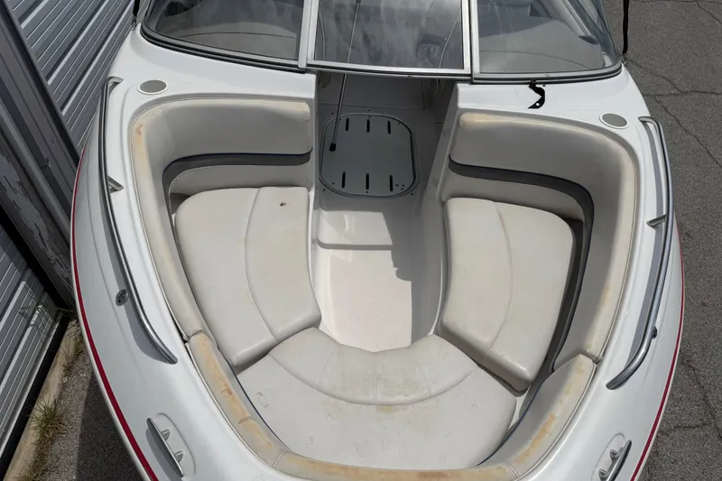 Slide: The Image of 2003 Four Winns 190 Horizon boat interior with white seating and open bow area. - 8