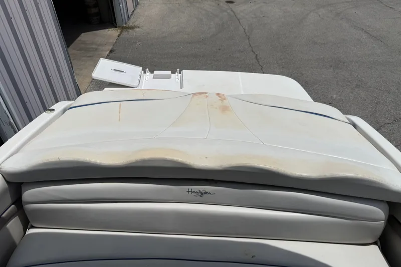 Slide: The Image of 2003 Four Winns 190 Horizon boat interior with worn upholstery and storage compartment. - 19