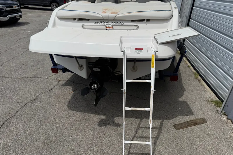 Slide: The Image of 2003 Four Winns 190 Horizon boat with ladder and propeller, parked on pavement. - 4