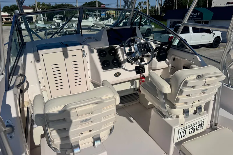 Slide: The Image of 2004 Grady-White Gulfstream 232 boat interior with steering wheel and seating. - 15