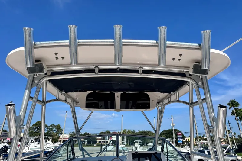 Slide: The Image of 2004 Grady-White Gulfstream 232 boat with T-top and rod holders under clear blue sky. - 16