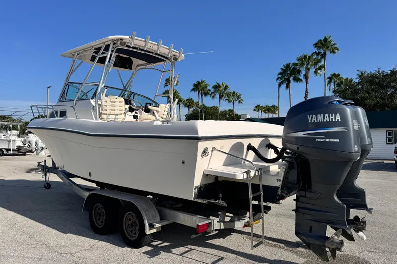 Slide: The Image of 2004 Grady-White Gulfstream 232 boat with Yamaha engine on trailer, palm trees in background. - 8