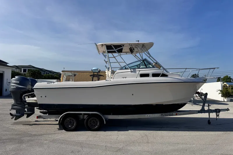 Slide: The Image of 2004 Grady-White Gulfstream 232 boat on trailer, side view, clear sky background. - 10