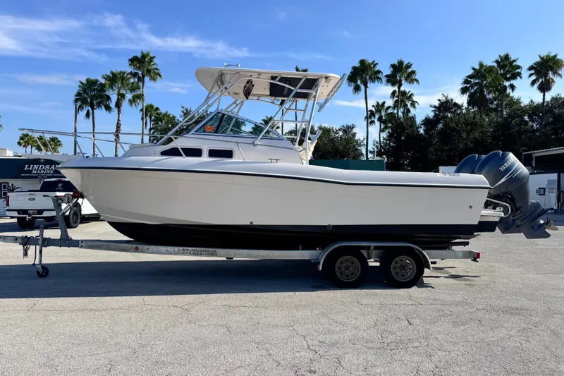 The Image of 2004 Grady-White Gulfstream 232 boat on trailer, palm trees in background. - 0