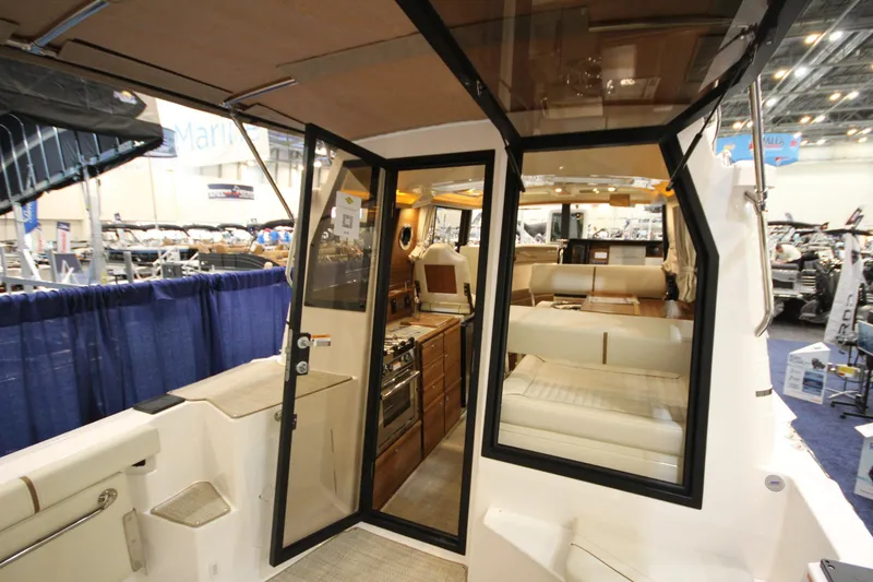 Slide: The Image of Interior view of 2026 Ranger Tugs R-27 boat at a marine exhibition. - 4