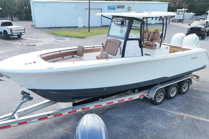 Slide: The Image of 2027 Sea Hunt Gamefish 28 Forward Seating boat on trailer, parked outdoors. - 3