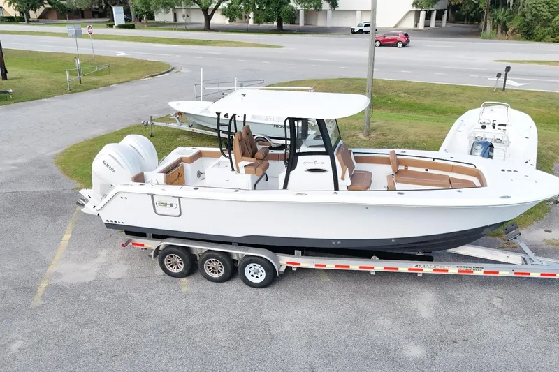 The Image of 2027 Sea Hunt Gamefish 28 Forward Seating boat on trailer, parked in a lot. - 1