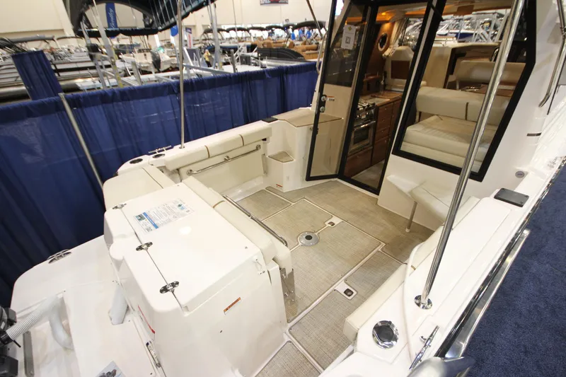 Slide: The Image of 2026 Ranger Tugs R-27 boat interior with seating and kitchen area. - 2