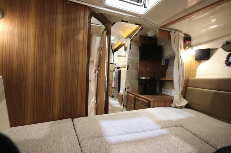 Slide: The Image of Interior of 2026 Ranger Tugs R-27, featuring cozy cabin with wood accents and modern amenities. - 22