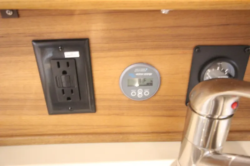 Slide: The Image of Electrical outlet and gauge panel on 2026 Ranger Tugs R-27 boat interior. - 13