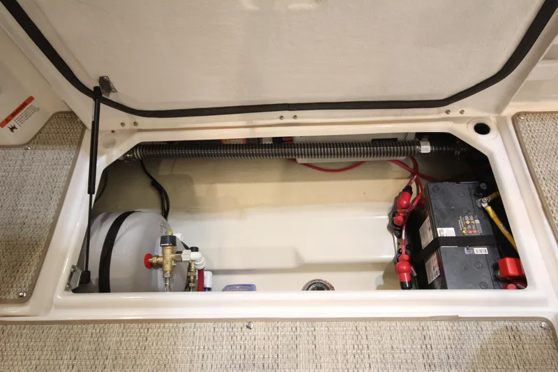 Slide: The Image of 2026 Ranger Tugs R-27 boat compartment with battery and equipment. - 7