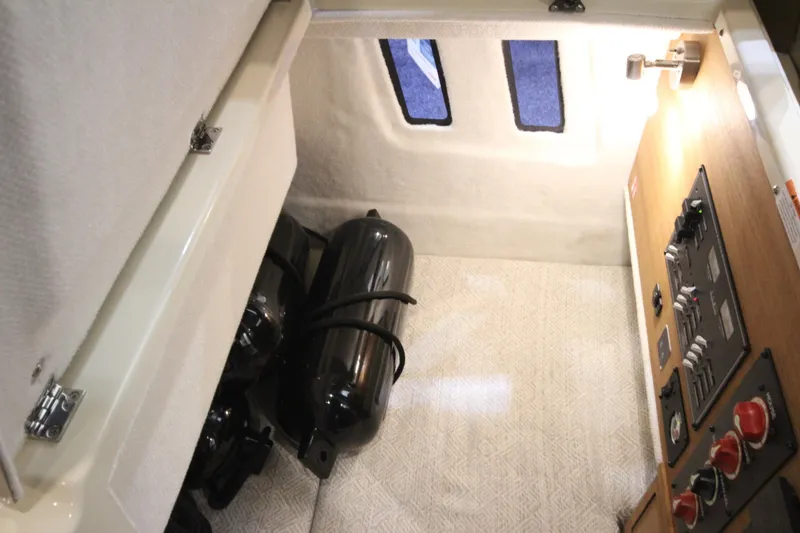 Slide: The Image of 2026 Ranger Tugs R-27 interior with control panel and storage area. - 19